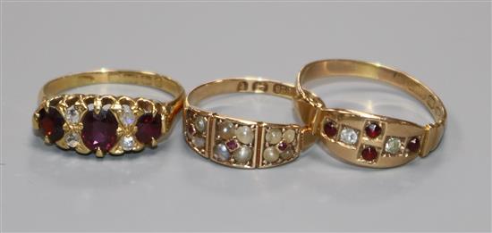 Two early 20th century 15ct gold and gem set rings and a similar 18ct gold and gem set ring.